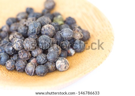 Black peppercorns isolated in a white background