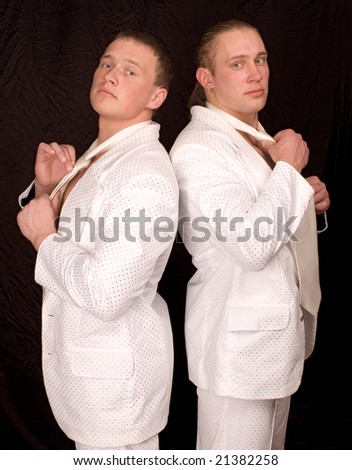 Two businessmen in white suits cost a back on a black background