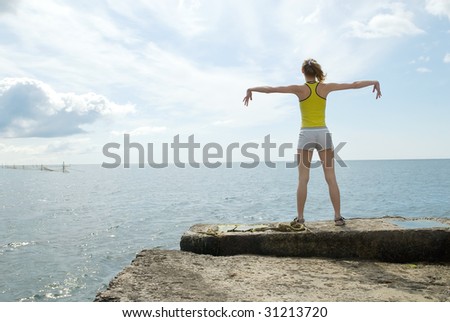 The young woman is engaged in gymnastics on sea