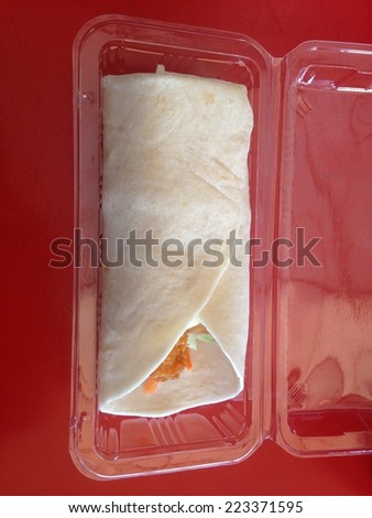 chicken with salad and salsa wrapped in a soft flour tortilla. in box