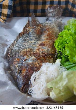 fish grilled with salt is thai food.it has many vegetable, noodles and spicy sauce(sea food sauce)