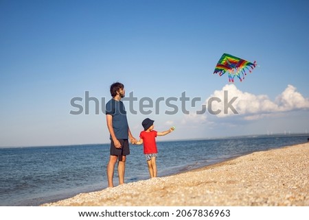 Similar – Image, Stock Photo Boy with striped kite on the beach in ICM technique.