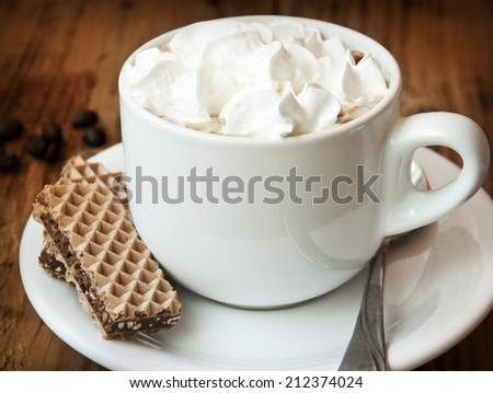 Fresh Cup of Cappuccino Coffee with Softy Cream and Chocolate Cookies