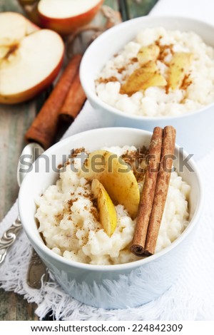 Rice Pudding with Apple Slices and Cinnamon Spice Sticks