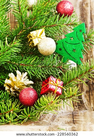 Fir Tree with Christmas Tree Decoration and Glitter Balls and Gifts on Wooden Background