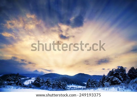Winter Landscape with Sun Rays and Dramatic Sky