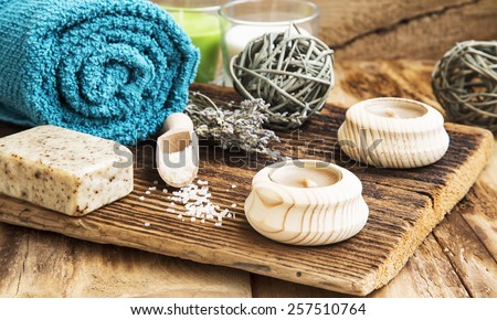 Calm Spa Scene, Wellness Setting with Towel,Natural Soap ,Candles and Lavender Bouquet on Wooden Table