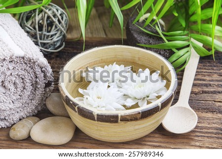 Beautiful White Flowers in the Water in a Bamboo Bowl.Spa and Wellness Concept