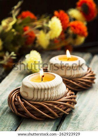 Calm Spa Setting with Burning Candles and Flowers on Wooden Table