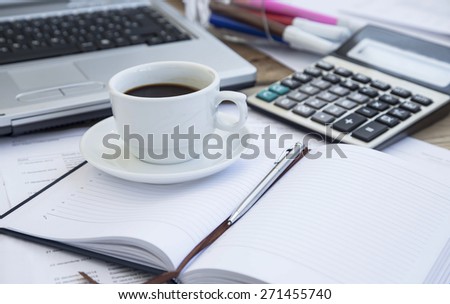 Coffee Cup at Office with Paperwork, Agenda and Pen,Calculator.Coffee Break