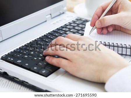 Hands Typing on Computer Keyboard and Taking Notes at Office.Office Business Worker Keyboarding