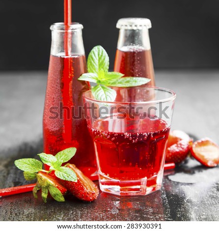 Refreshing Red Juice with Strawberries and Mint in Transparent Bottles and Glass with Straws