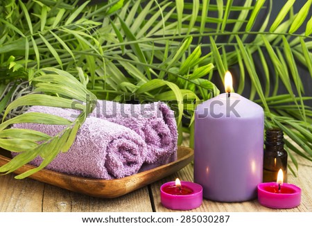 Scented Candles Burning.Spa Setting with Candles, Towels and Aromatherapy