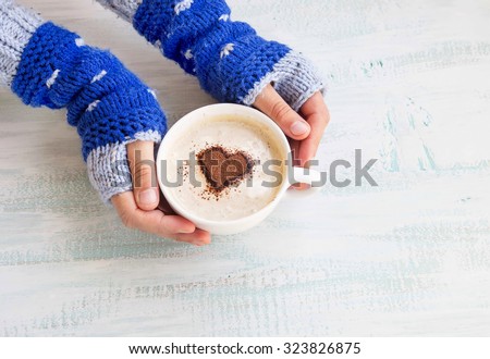 Holding Coffee Latte Cup with Cocoa Shape and Cozy Wool Hands Warmers