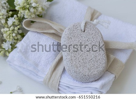 Beauty spa with body care pumice stone on white towels with lilac flowers, bath spa products  ストックフォト © 