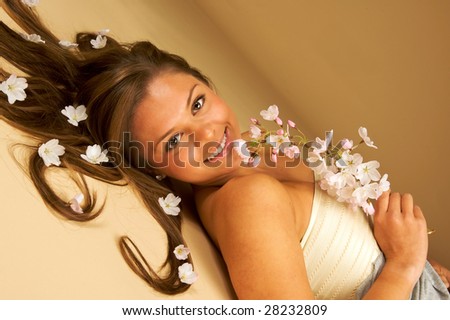 Sweet beautiful model with blossoms in her hair