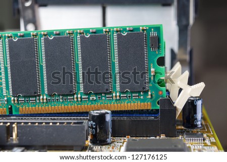 Memory module in a PC is being removed from the slot on the mother board.