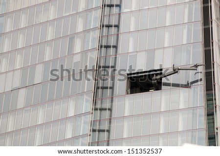 Office block maintenance arm on the side of a tall skyscraper