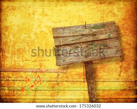 Blank wooden sign on yellow wall