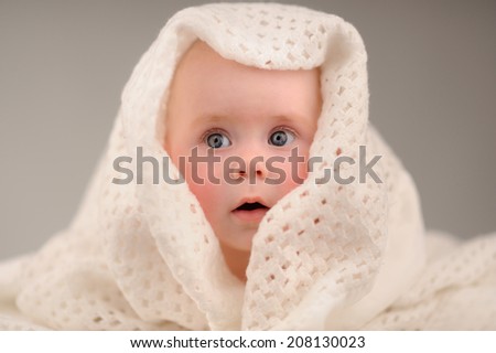 baby girl is hiding under the white blanket with different emotions