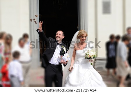 Bride and groom leaving the church after a wedding ceremony