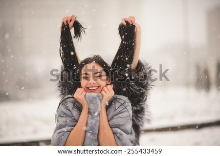 funny girls enjoying winter weather  - with film effect with small grain
