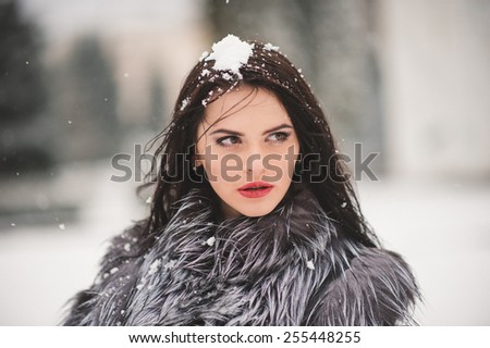 winter portrait of Beauty girl with snow - with film effect with small grain