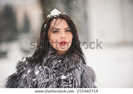 winter portrait of Beauty girl with snow - with film effect with small grain