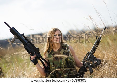 Beautiful army girl with gun  outdoor