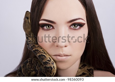 Beautiful Brunette Girl With A Snake Around Her Head Stares At The ...