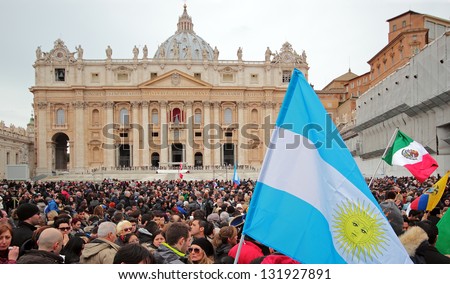 ROME, ITALY - MARCH 17: The crowd is waiting in St. Peter Square before the first Angelus prayer of Pope Francis I, a flag of Argentina in foreground, on March 17, 2013 in Vatican City, Rome, Italy