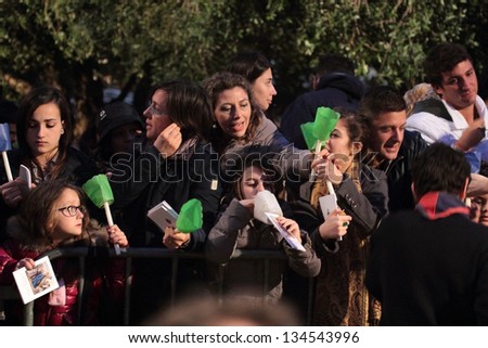 ROME - March 29: People attend the Way of the Cross chaired by the Pope Francis at the Colosseum on Good Friday on March 29, 2013 in Rome. People received candles and booklets for the ceremony.