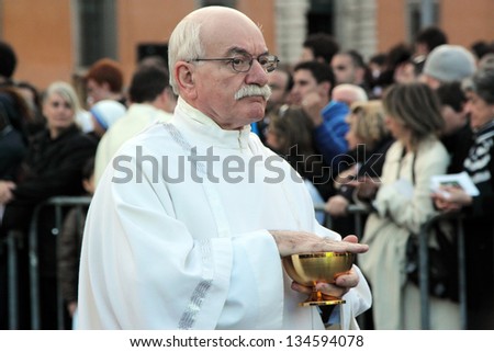 ROME, ITALY - April 07: A priest gives the communion to the crowd with hosts and blesses during the settlement ceremony of Pope Francis in Basilica of St. John Lateran on April 07, 2013 in Rome