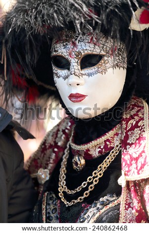 An elegant masked woman exhibited during the traditional festival of Carnival of Venice, Italy (2014 edition)