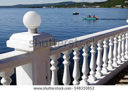 White parapet, the Angara River, motorboat