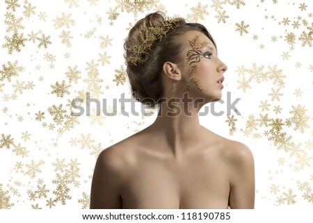 beautiful woman with christmas make-up and hair decoration, her face is turned at left and she looks in front of her