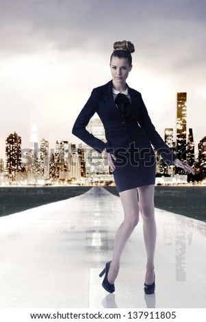business blonde woman wearing dark formal dress, elegant hair-style,  posing on trampoline and looking in camera