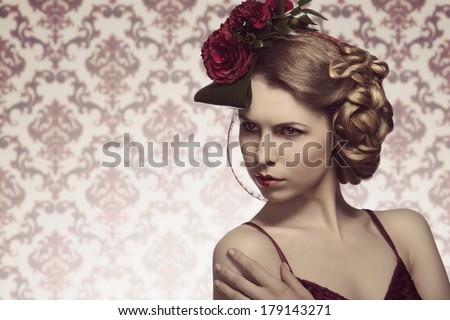 cute blonde girl posing in fashion shoot with romantic style, elegant floral hair-style, red sexy dress and heart shaped make-up