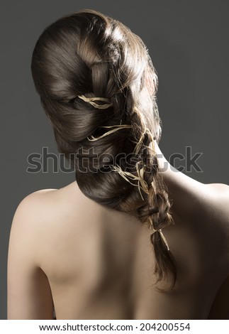 sensual naked girl with her back to the camera and a romantic, creative hairdo
