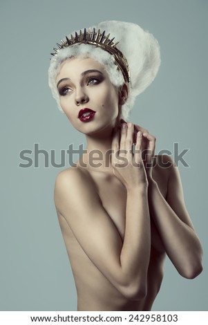 beauty portrait of naked woman with stylish make-up, creative artistic hairdo and golden accessories