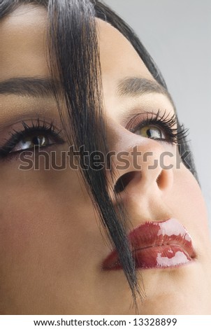 tuft of black hair on the face of a young cute woman with strong red lipstick