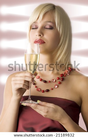 cute blond with cup of champagne in act to smell it