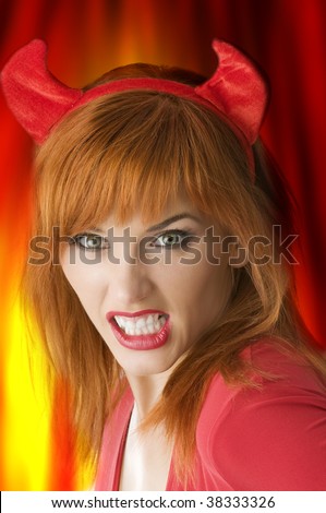 portrait of woman with halloween horns grinding her teeth like a vampire