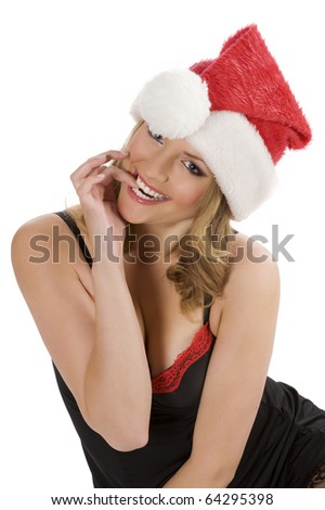 funny shot of a cute blond girl in act to bite her finger wearing a christmas red hat
