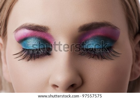 close up on the eyes of a beauty model with colorful and creative make up