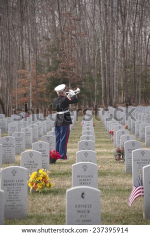 QUANTICO, VA-DEC 13, 2014: Quantico National Cemetery wreath laying event on Dec 13. Wreaths Across America , a non profit organization, placed wreaths after a ceremony that included the playing of taps