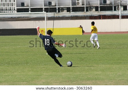 Football (soccer) player takes a goal kick
