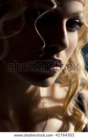 blonde in contrasting studio lighting