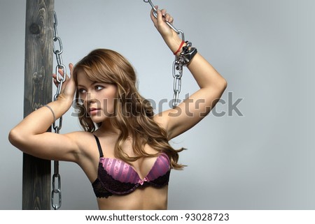 sexy brunette with long hair posing with a chain