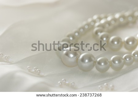 Pearl necklace on lace background,selected focus.